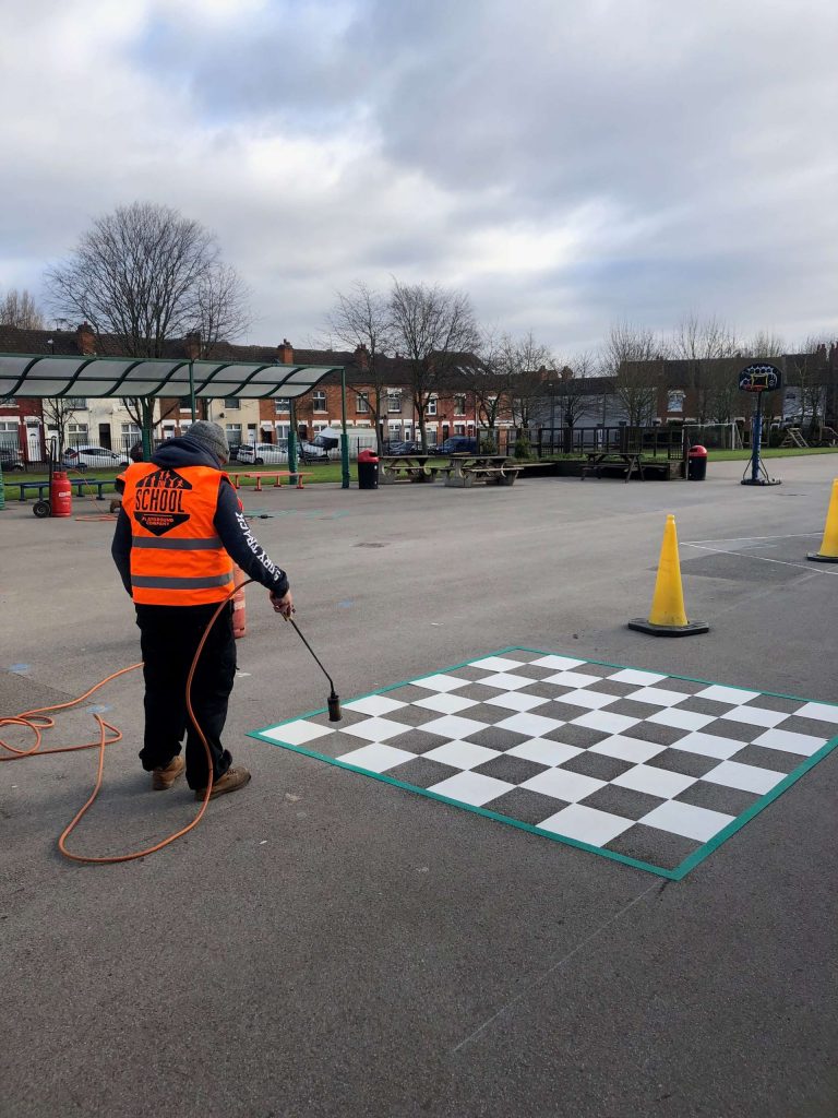 School Playground Company repairs and upkeep on chess board playground markings- playground installation